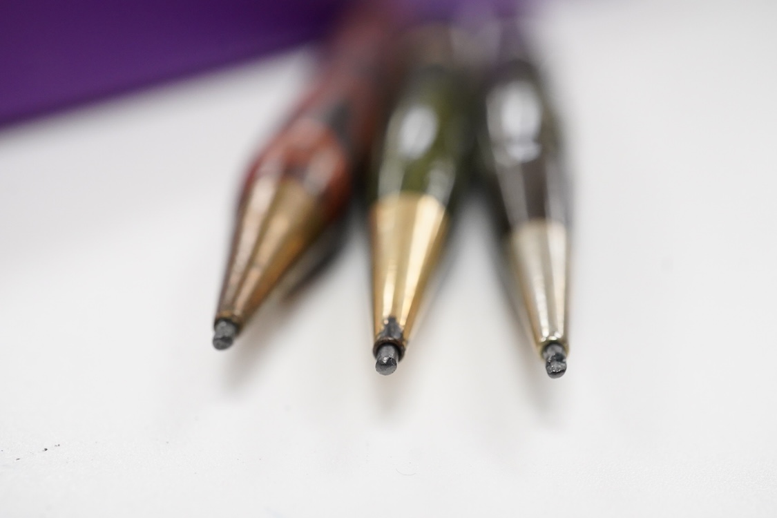 A collection of vintage pencils including an early enamel example